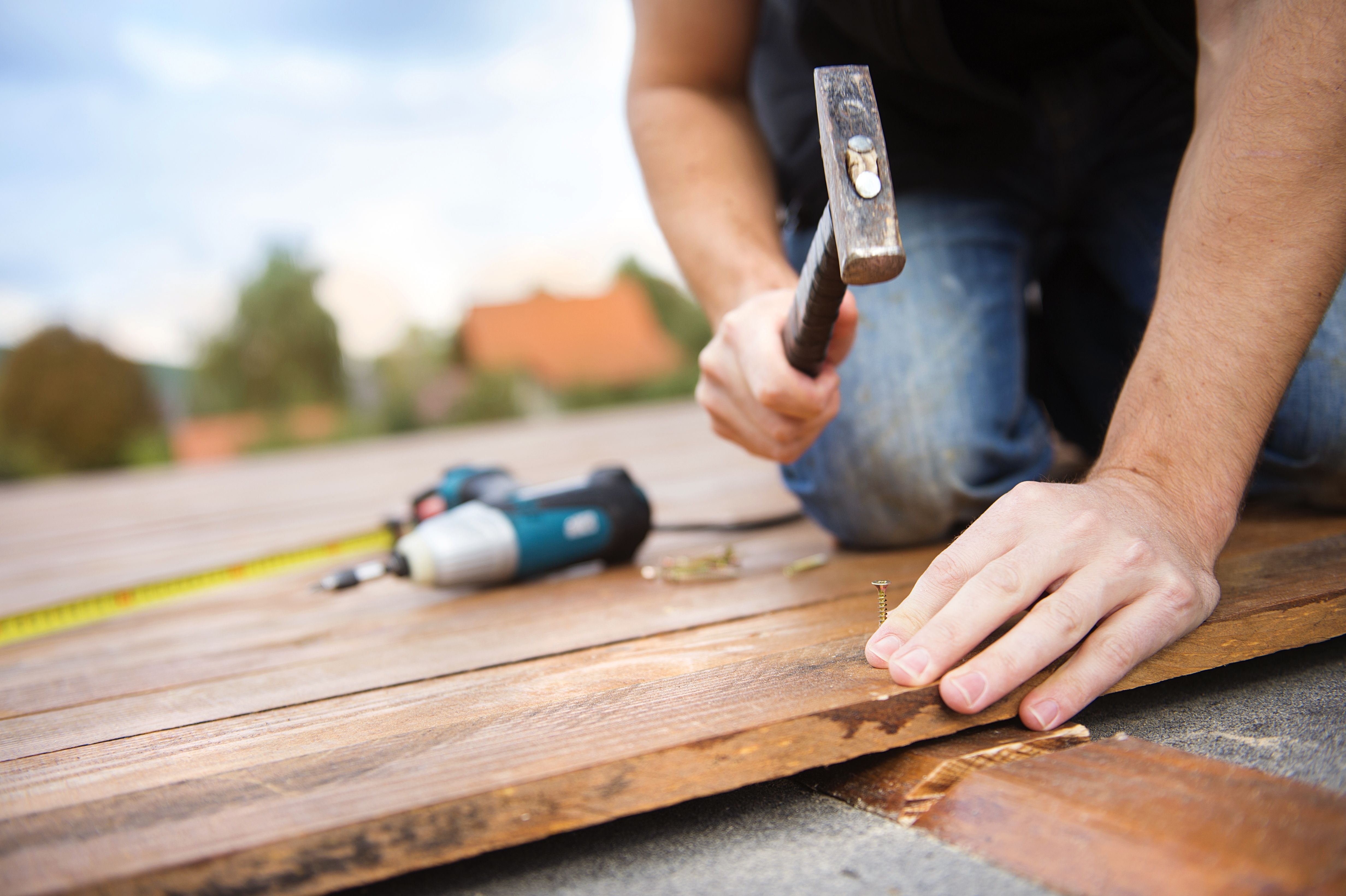 Graphicstock Handyman Installing Wooden Flooring In Patio Working With Hammer B0zhuthhbz