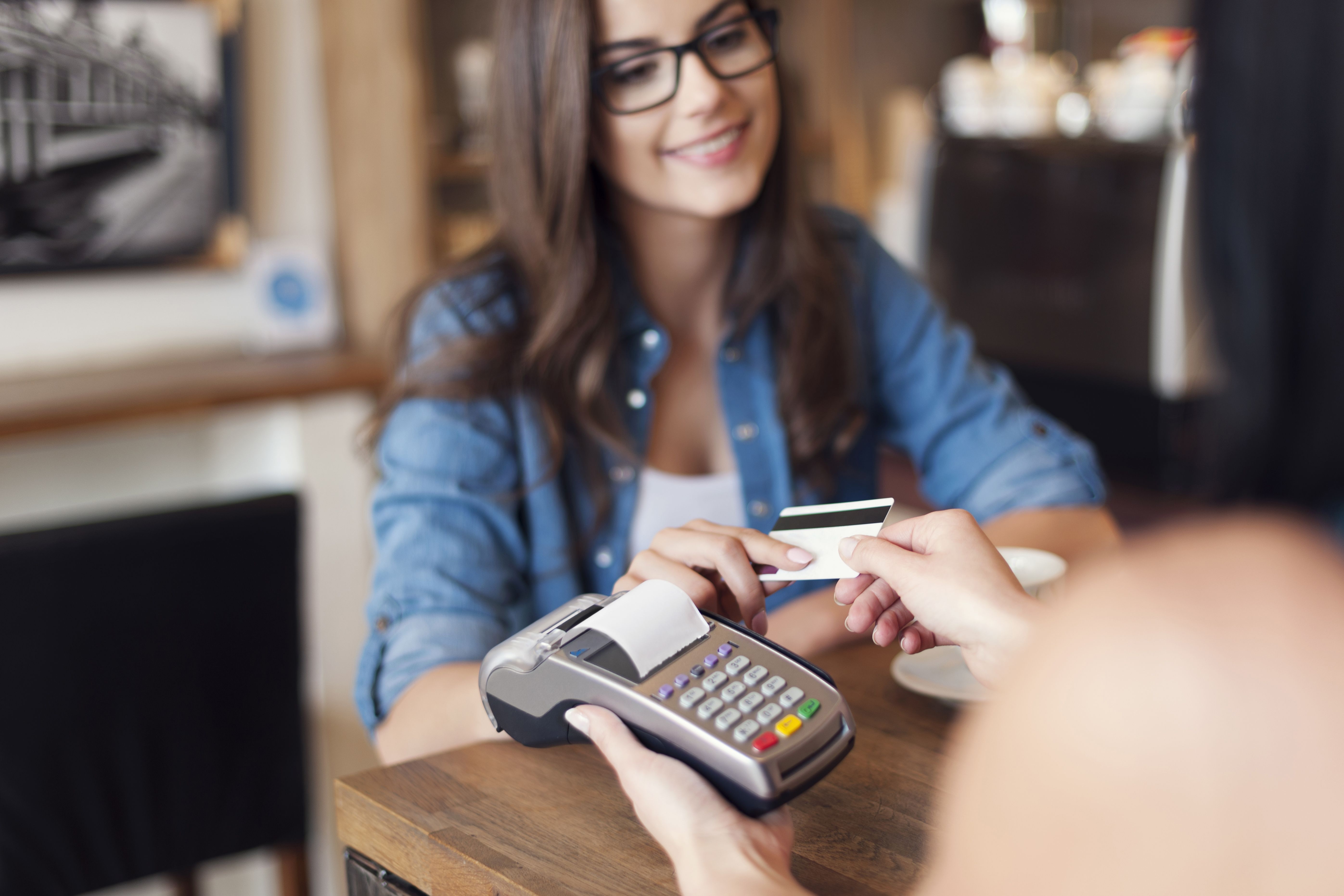Storyblocks Smiling Woman Paying For Coffee By Credit Card Bzndfadqm
